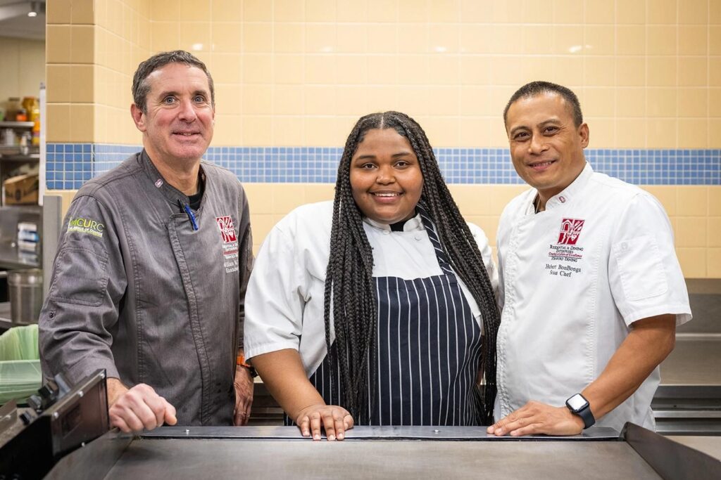 Sprouts intern Fayth Bishop, center, and her chef mentors, William Krupp, left, and Hubert Bongbonga. (Image credit: Keith Uyeda)